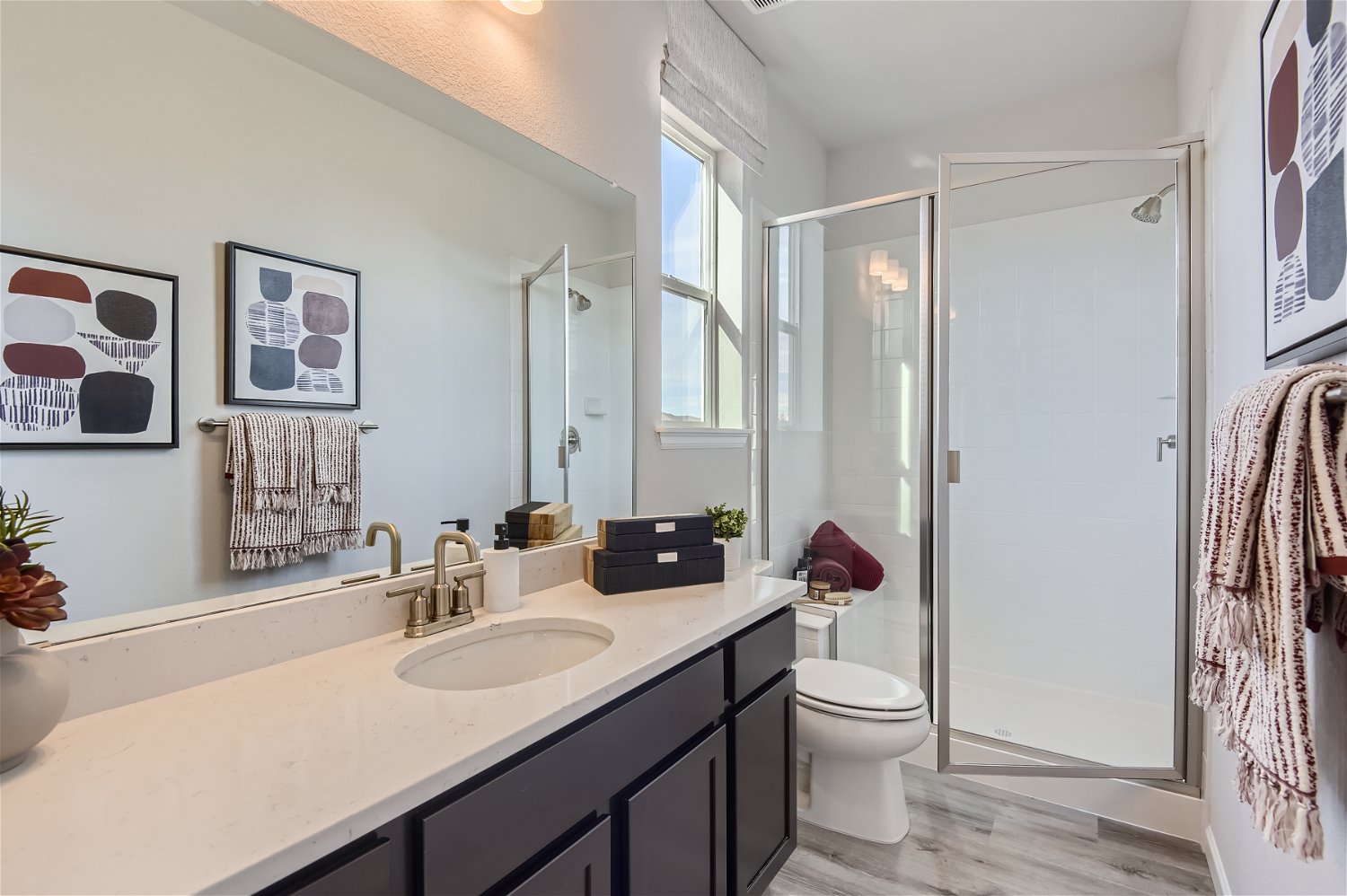A bathroom with a sink toilet and shower.