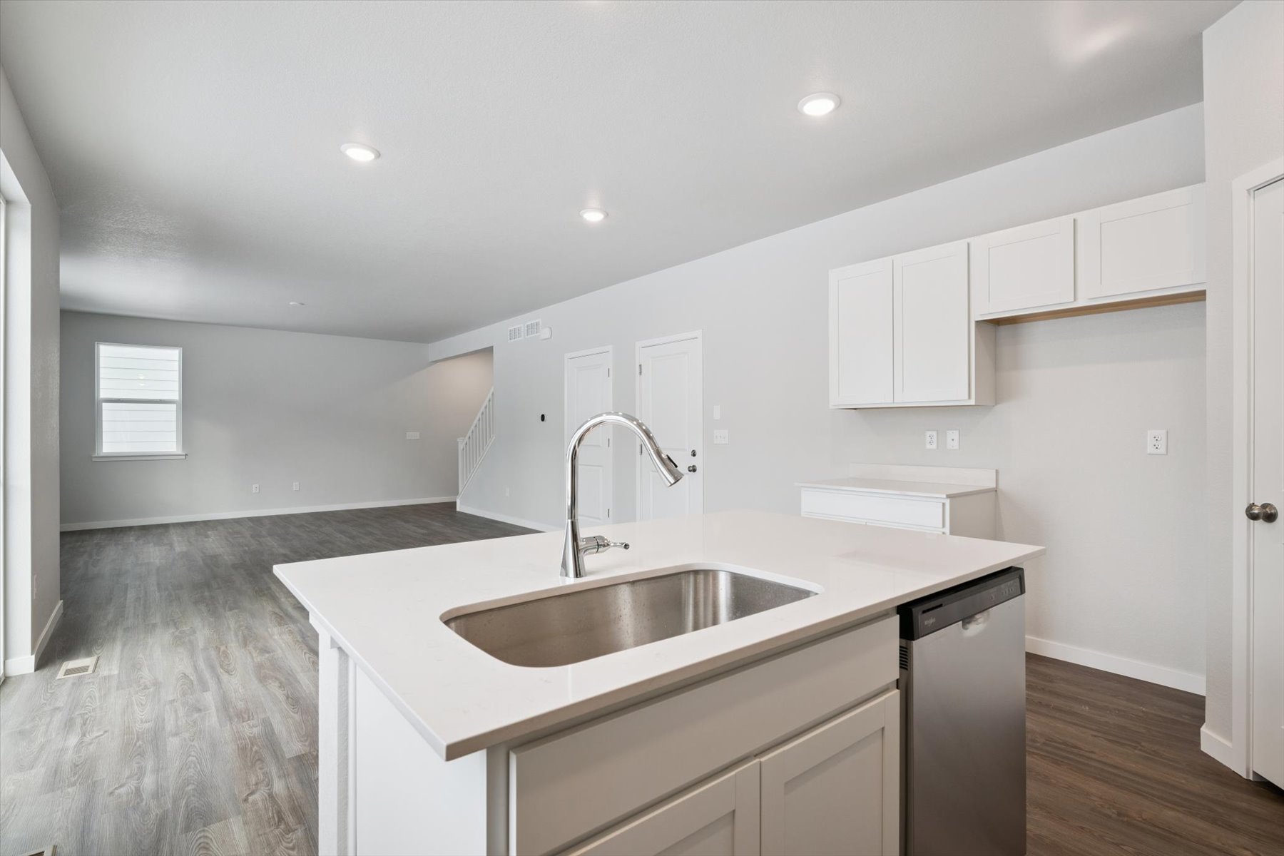 A kitchen with white cabinets.