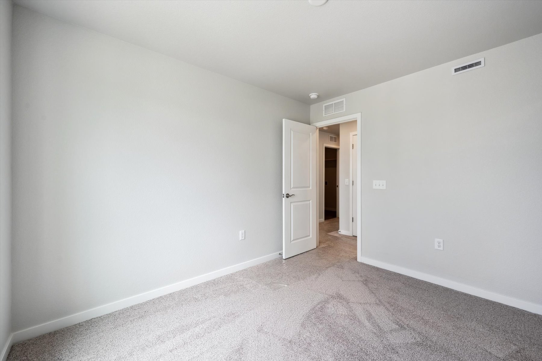 A hallway with white walls.