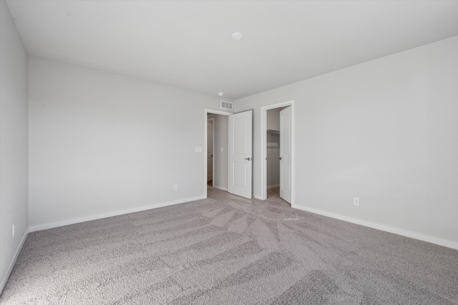 A hallway with white doors.
