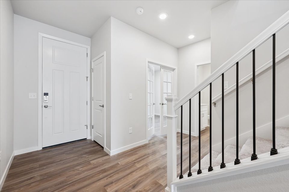 A room with white walls and black railings.