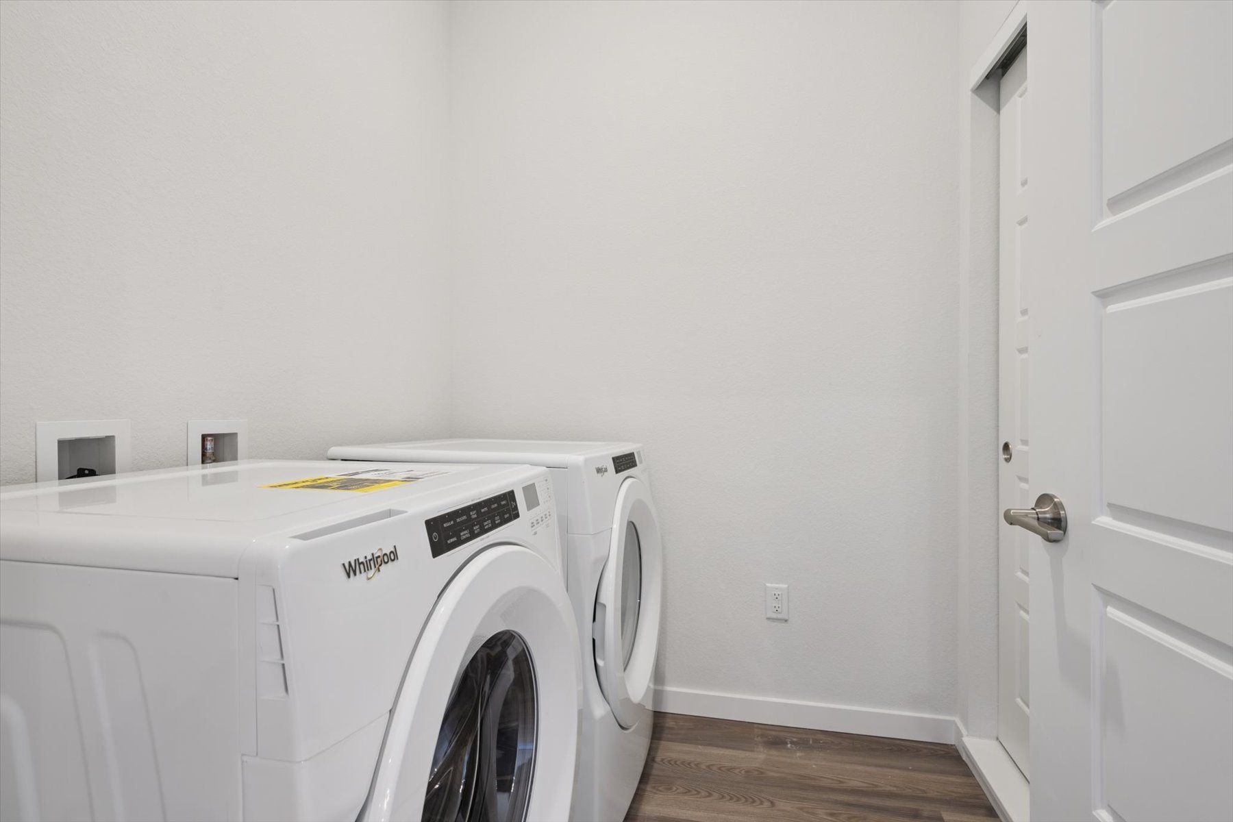 A white washing machine in a room.