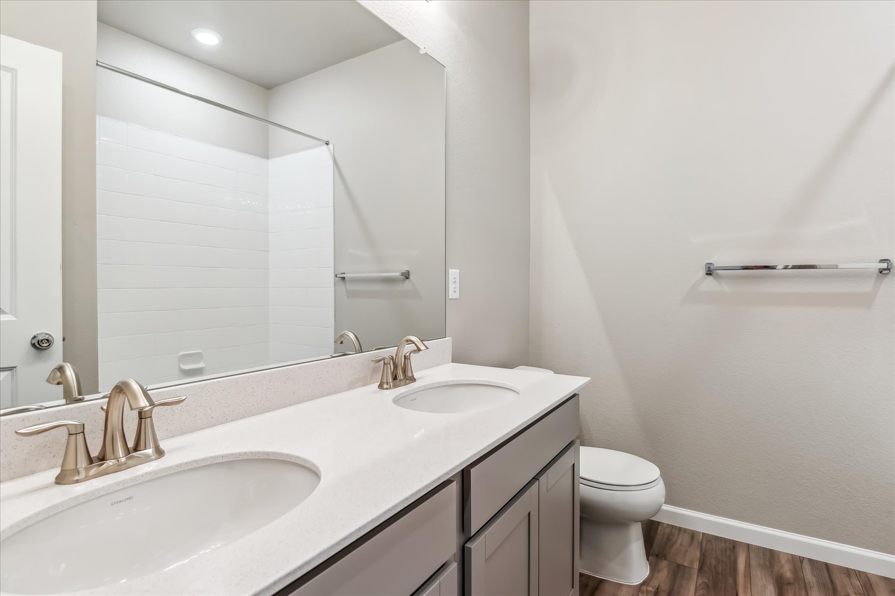 A bathroom with a large mirror.