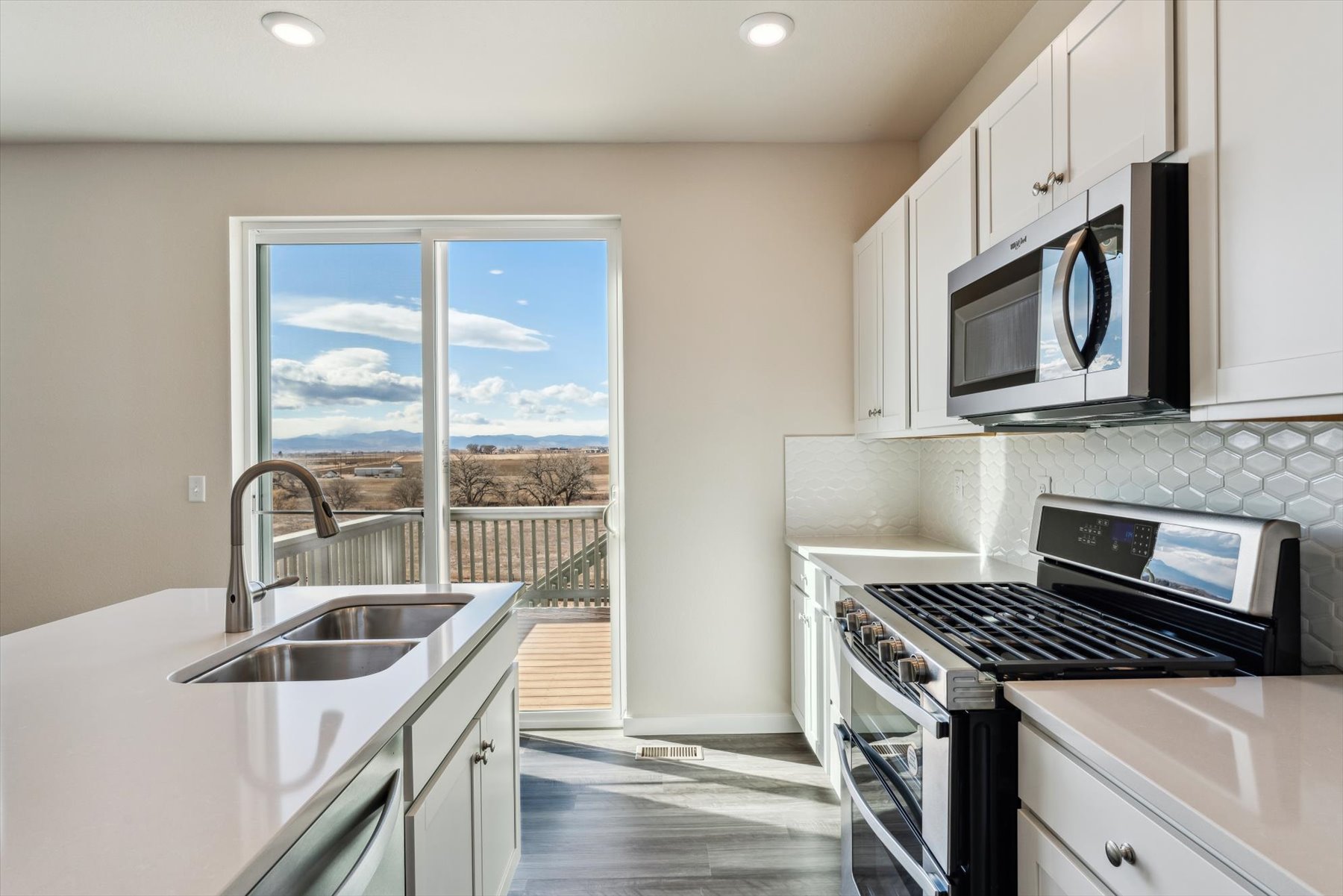A kitchen with a view of the ocean.
