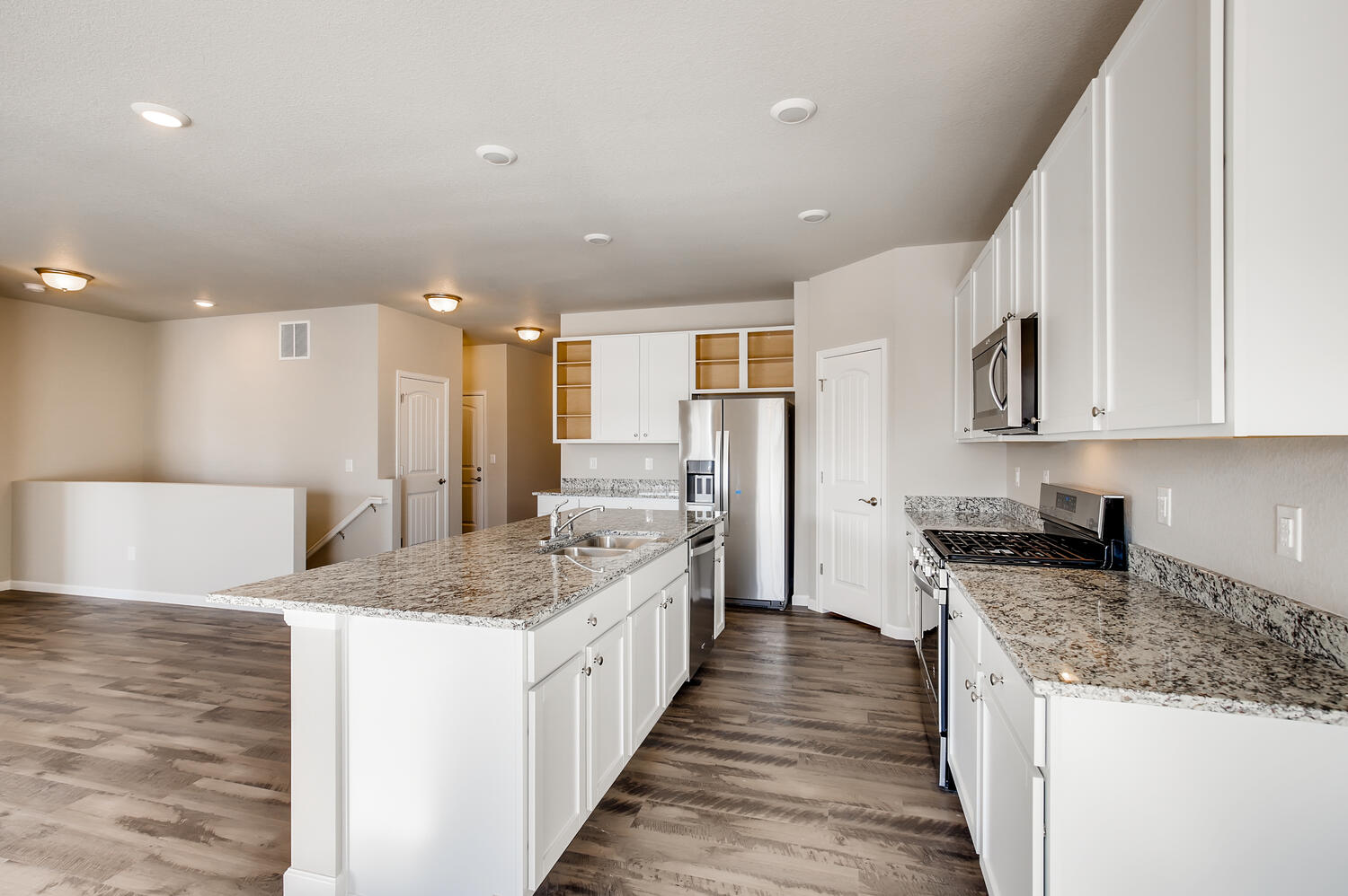 A kitchen with white cabinets.