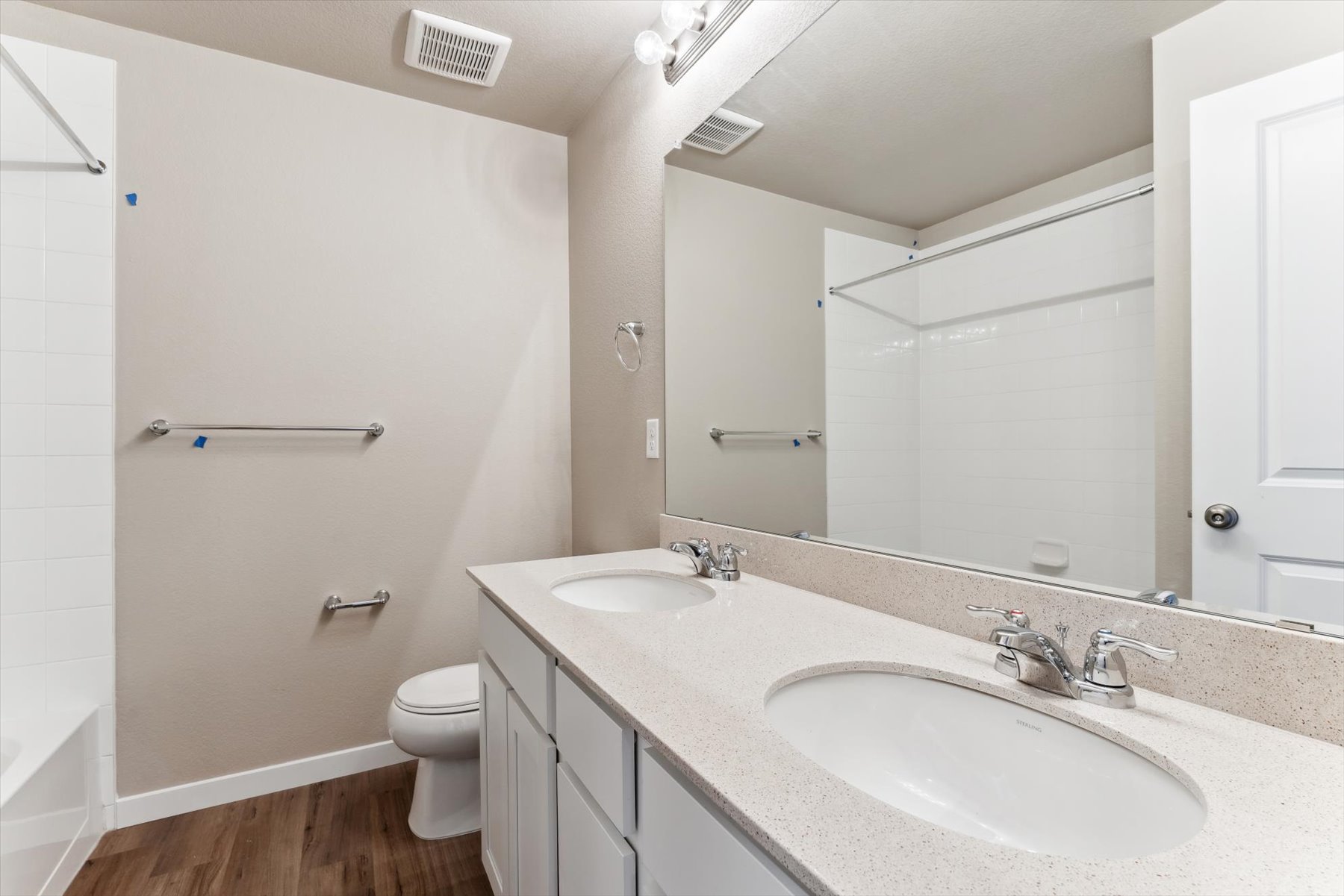 A bathroom with a large mirror.
