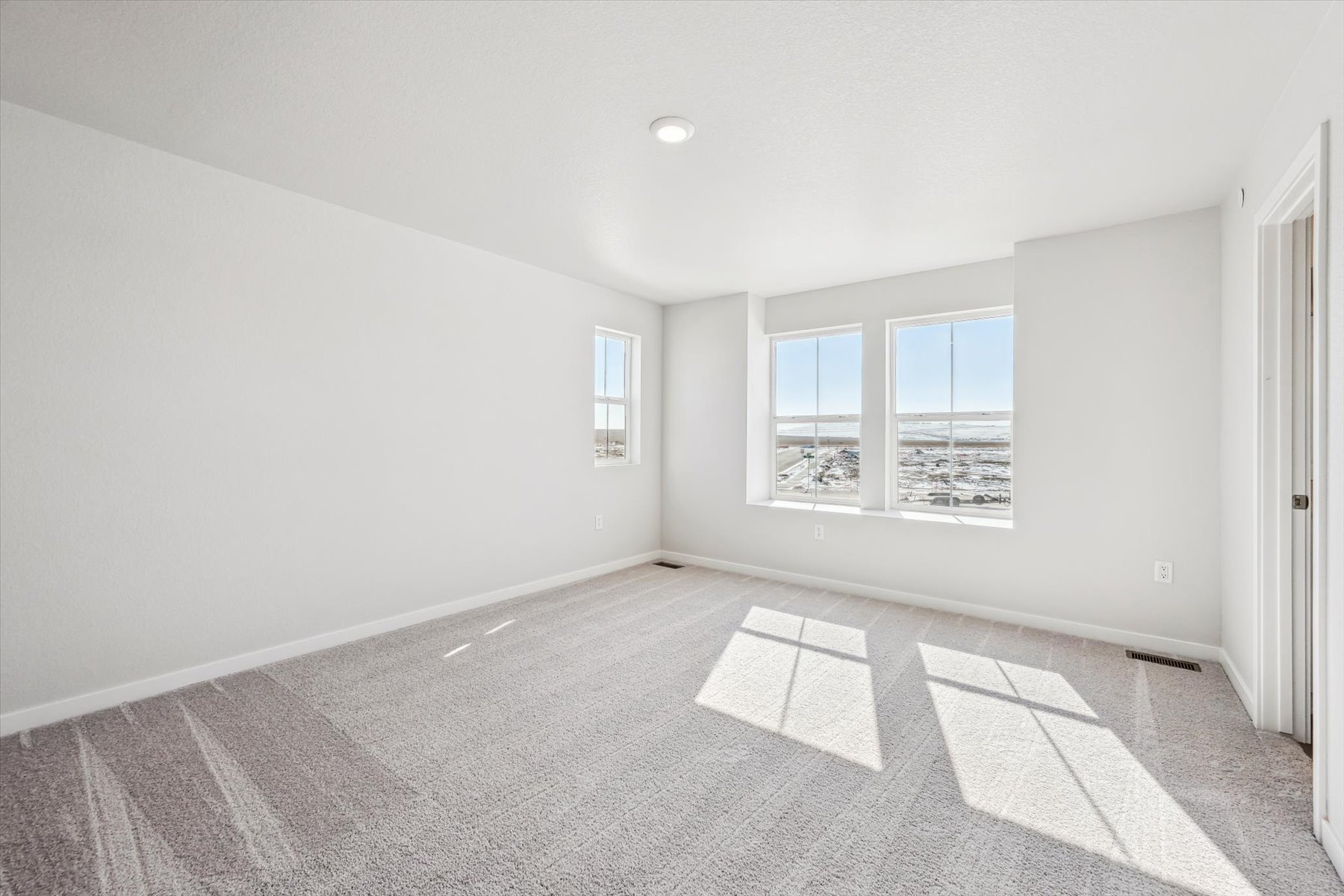 A room with a tile floor and windows.
