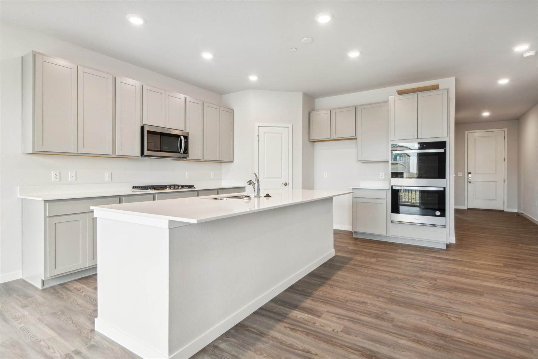 A kitchen with white cabinets.