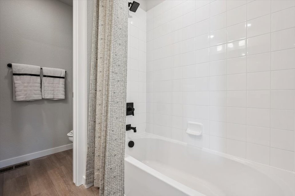 A bathroom with a bathtub and toilet.