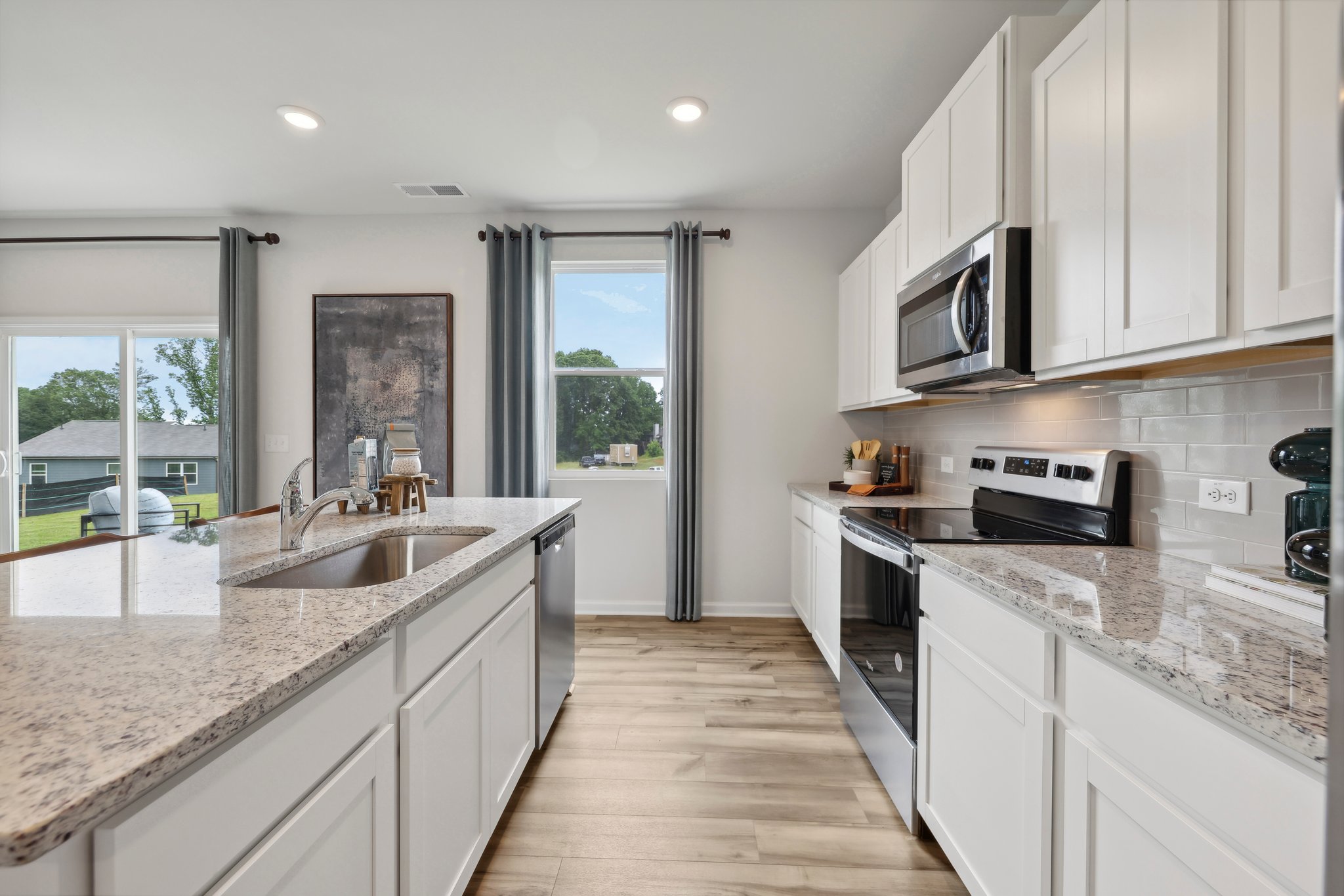 A kitchen with white cabinets.