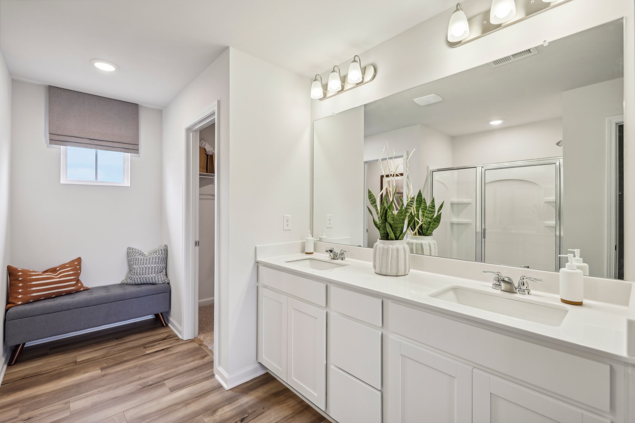 A bathroom with a large mirror.