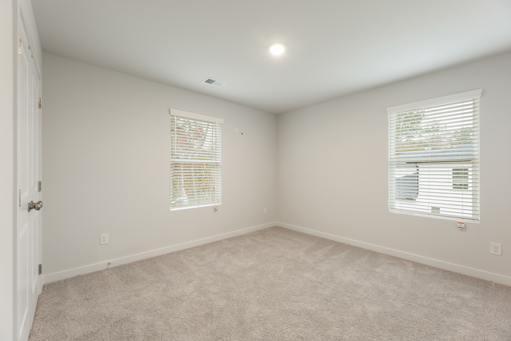 A room with a window and blinds.