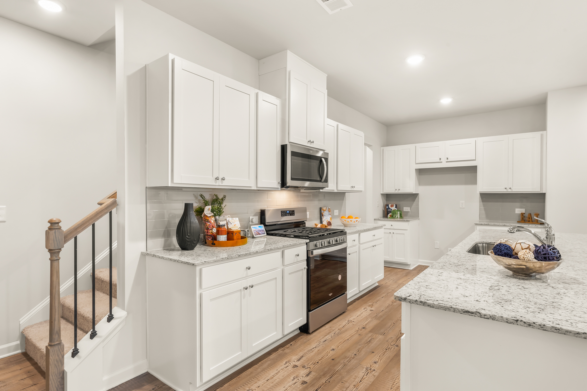 A kitchen with white cabinets.