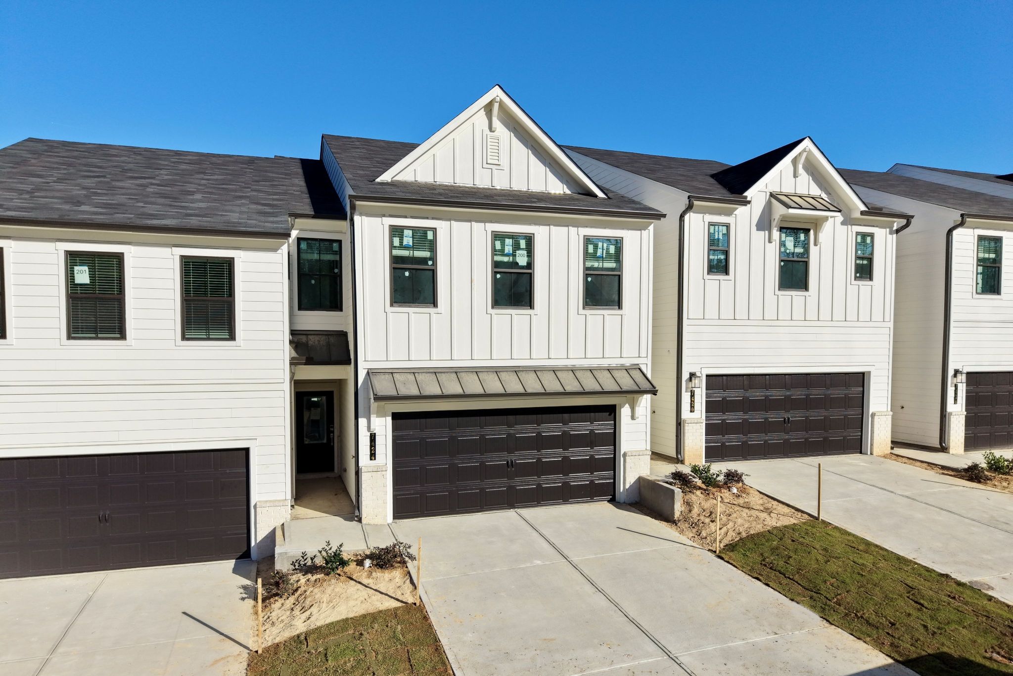 A white house with a garage.