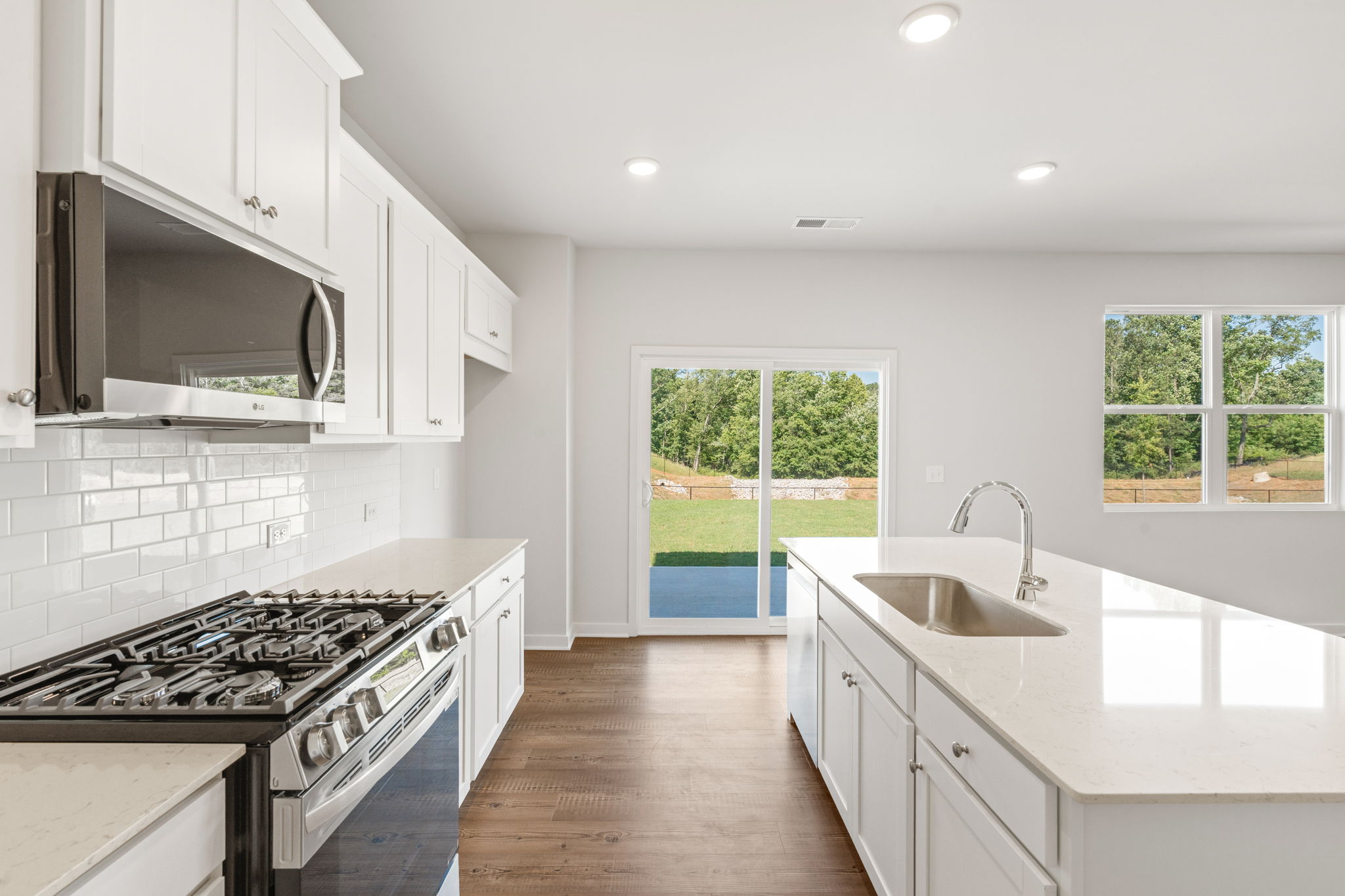 A kitchen with white cabinets.