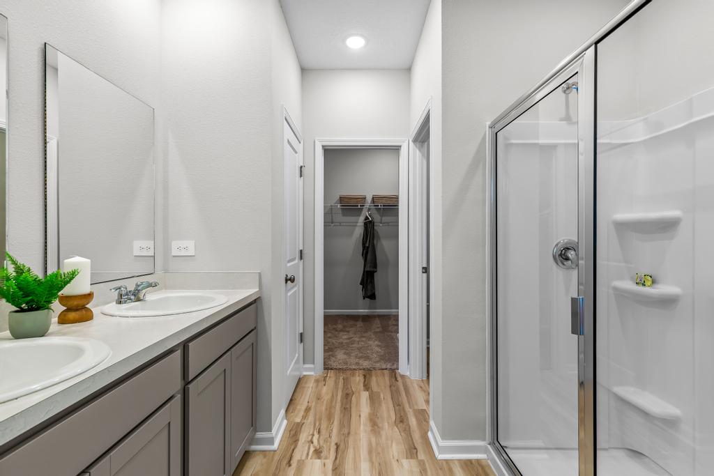 A bathroom with a shower and sink.