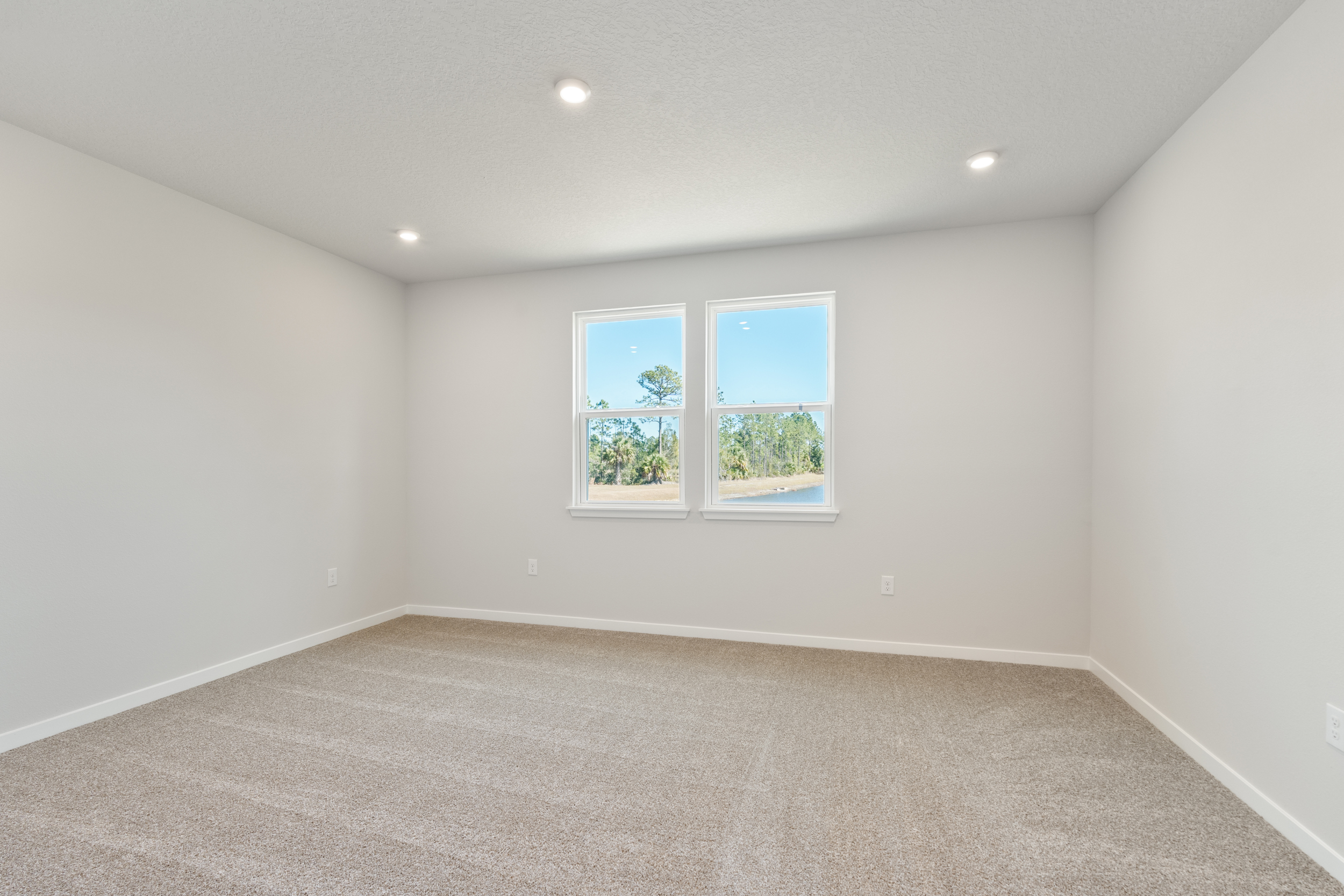 Lot 65 Primary Bedroom with Two Windows with Water View at Seminole Palms