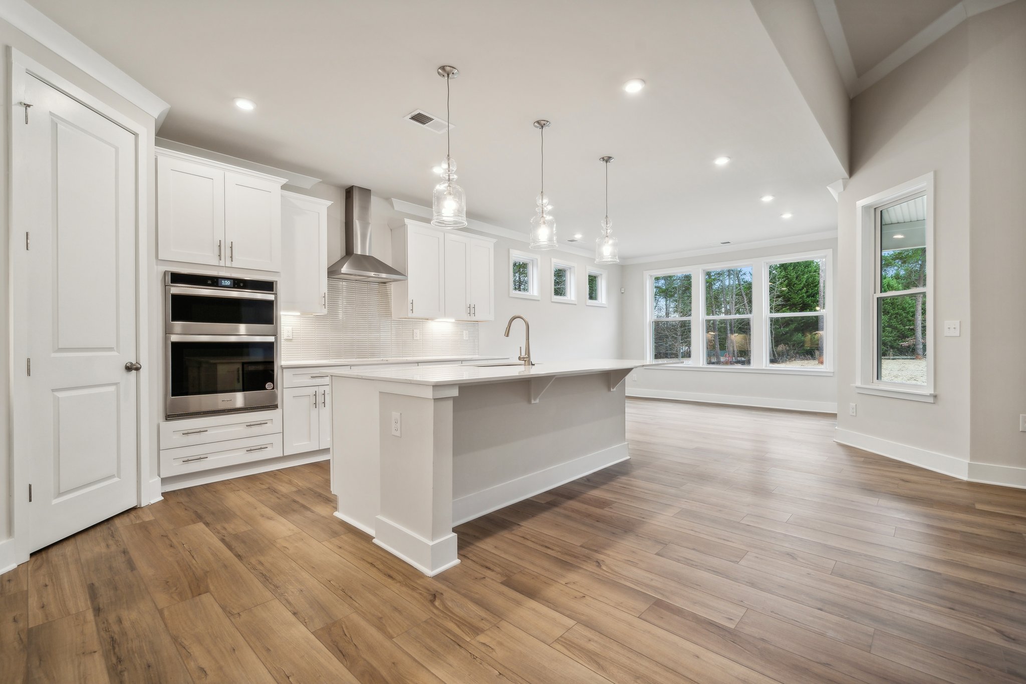 A kitchen with white cabinets.