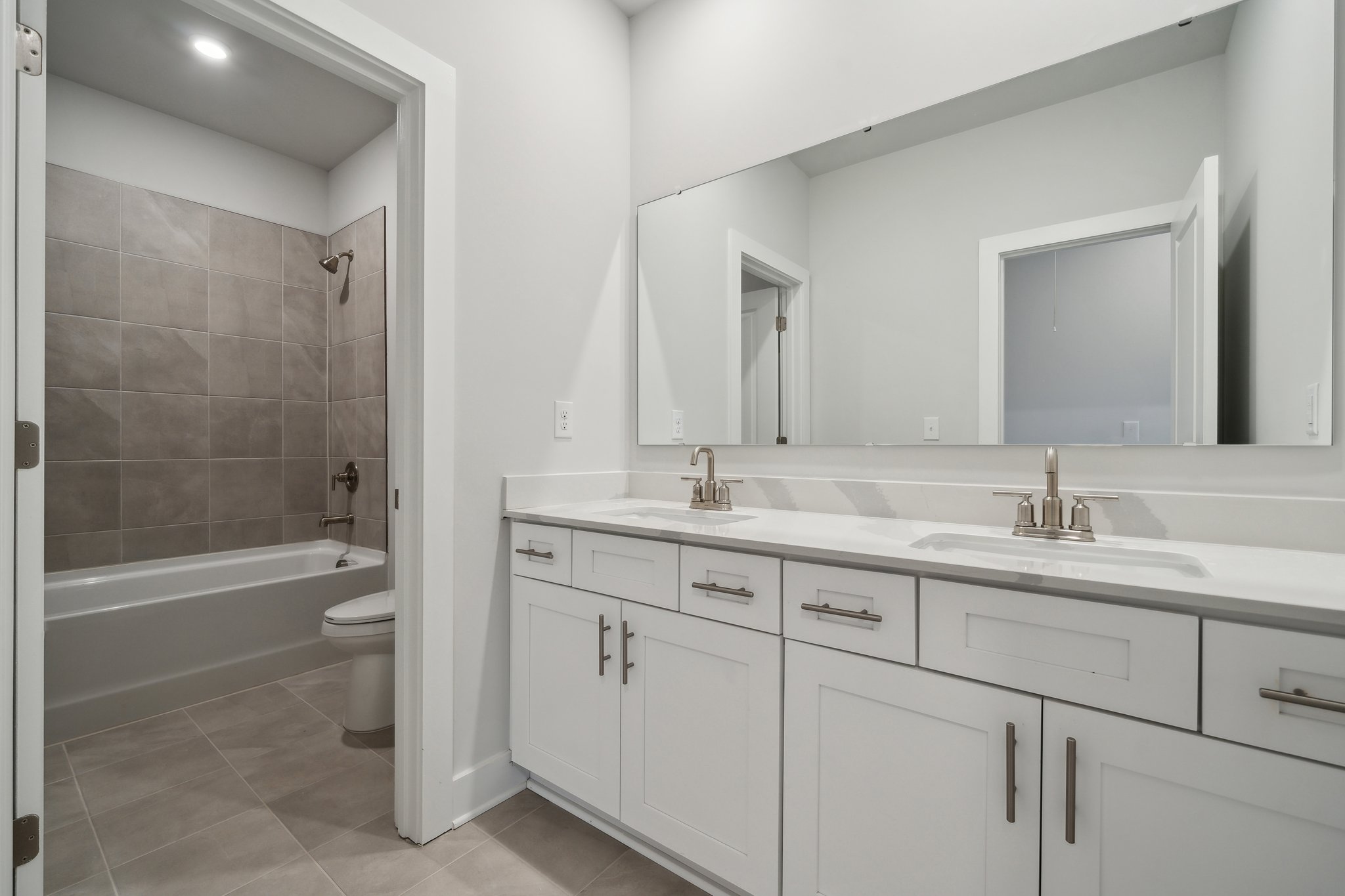 A bathroom with a tub sink and toilet.