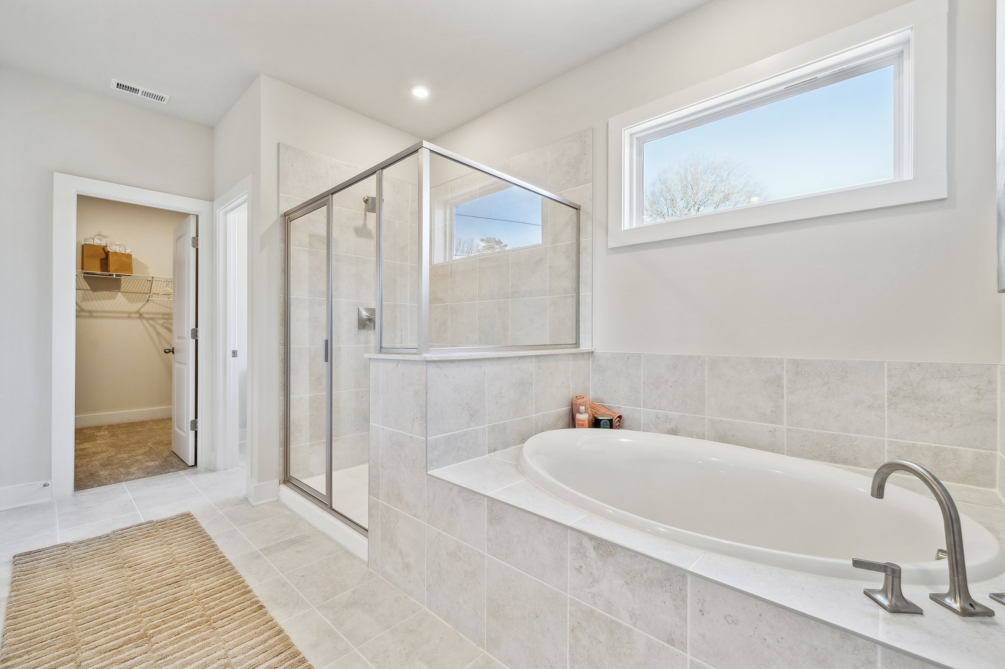 A bathroom with a tub and shower.