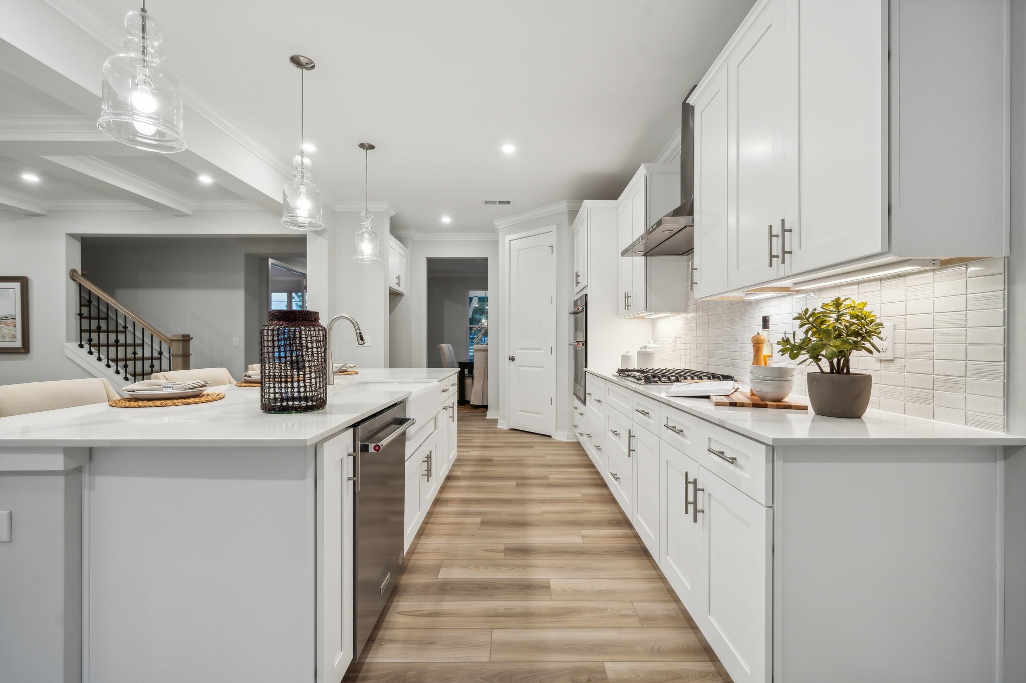 A kitchen with white cabinets.