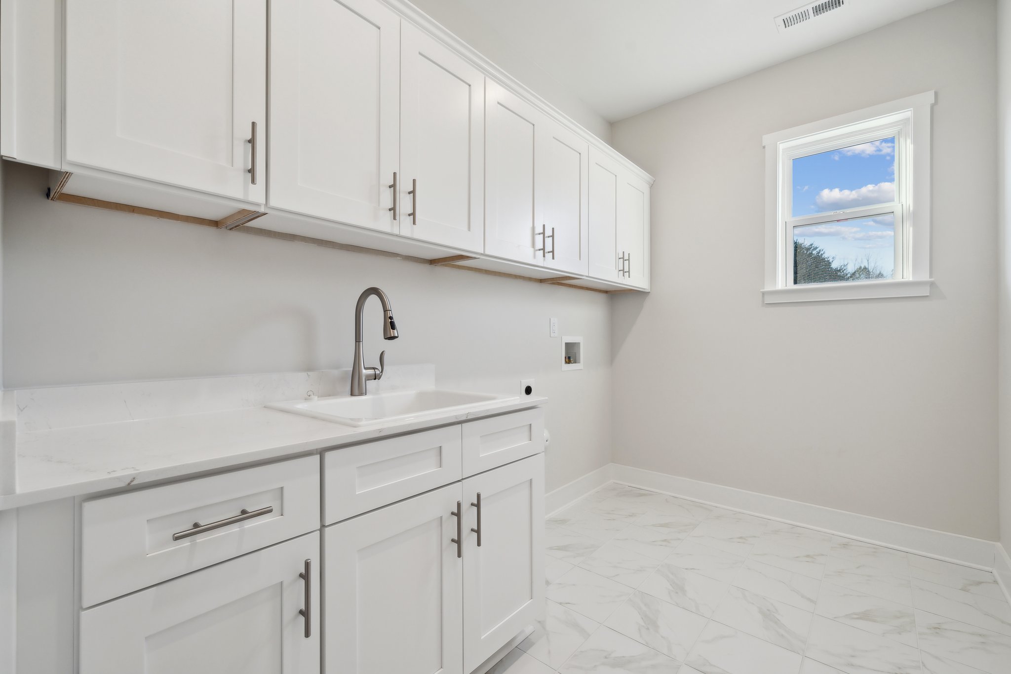 A white kitchen with white cabinets.