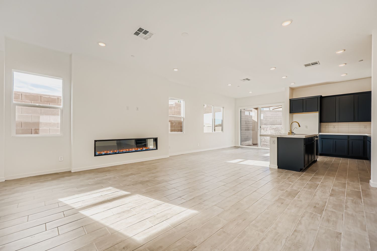 A large empty room with a fireplace.