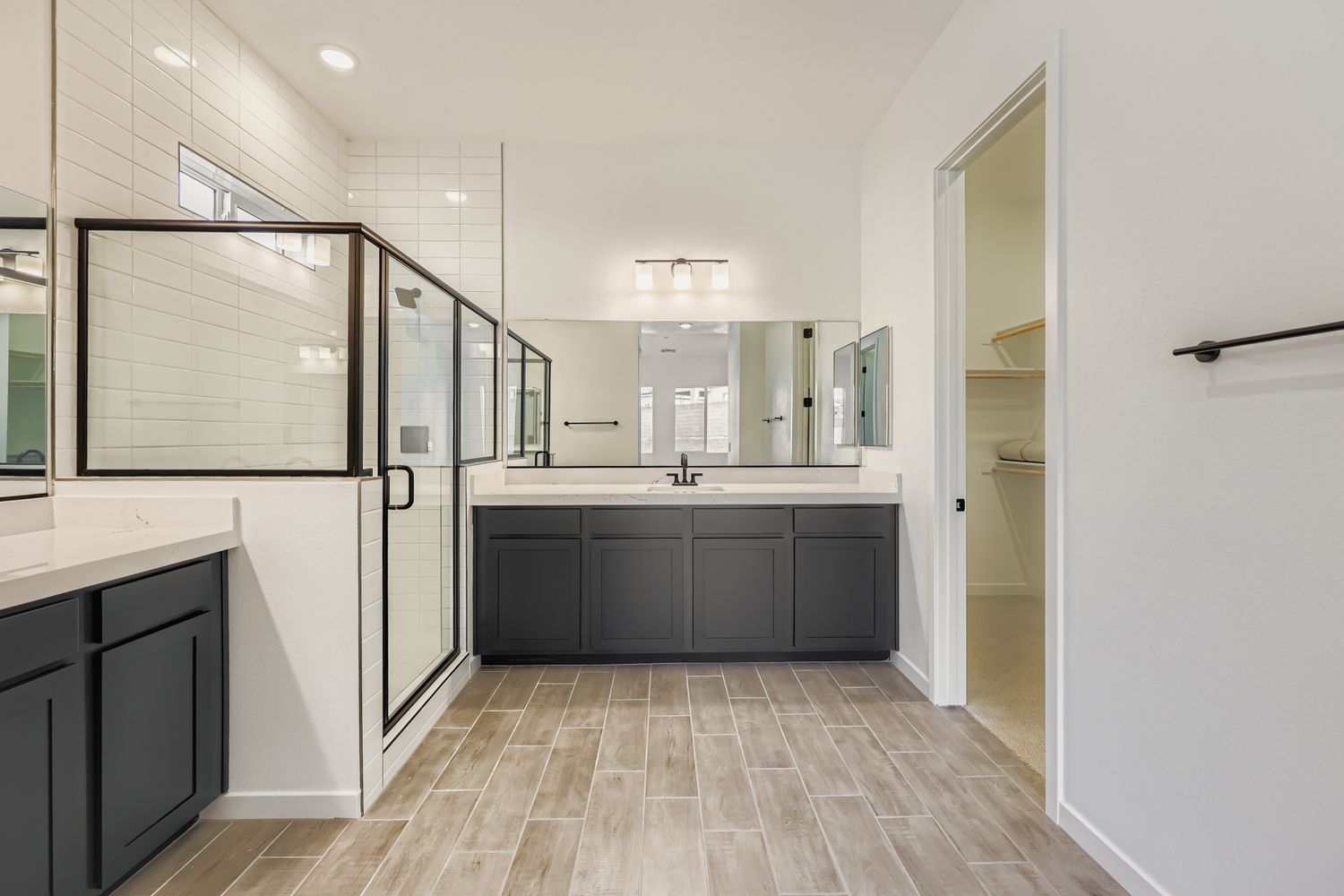 A bathroom with black cabinets.