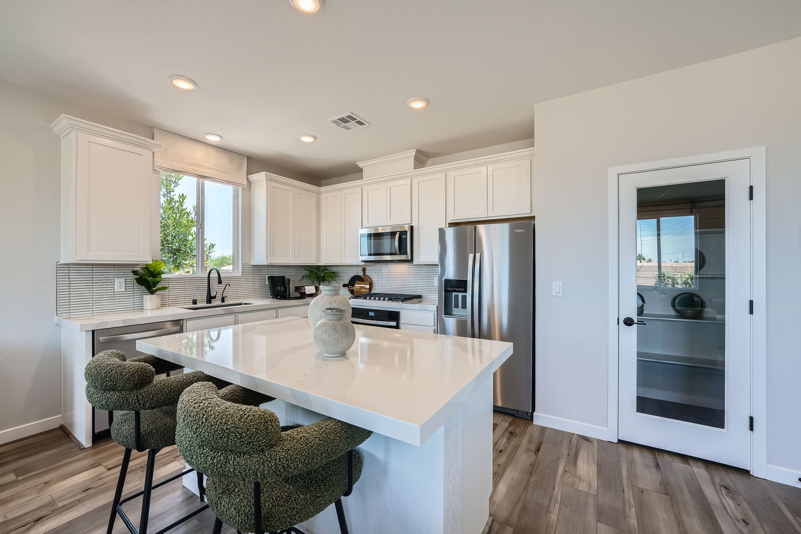 A kitchen with white cabinets.
