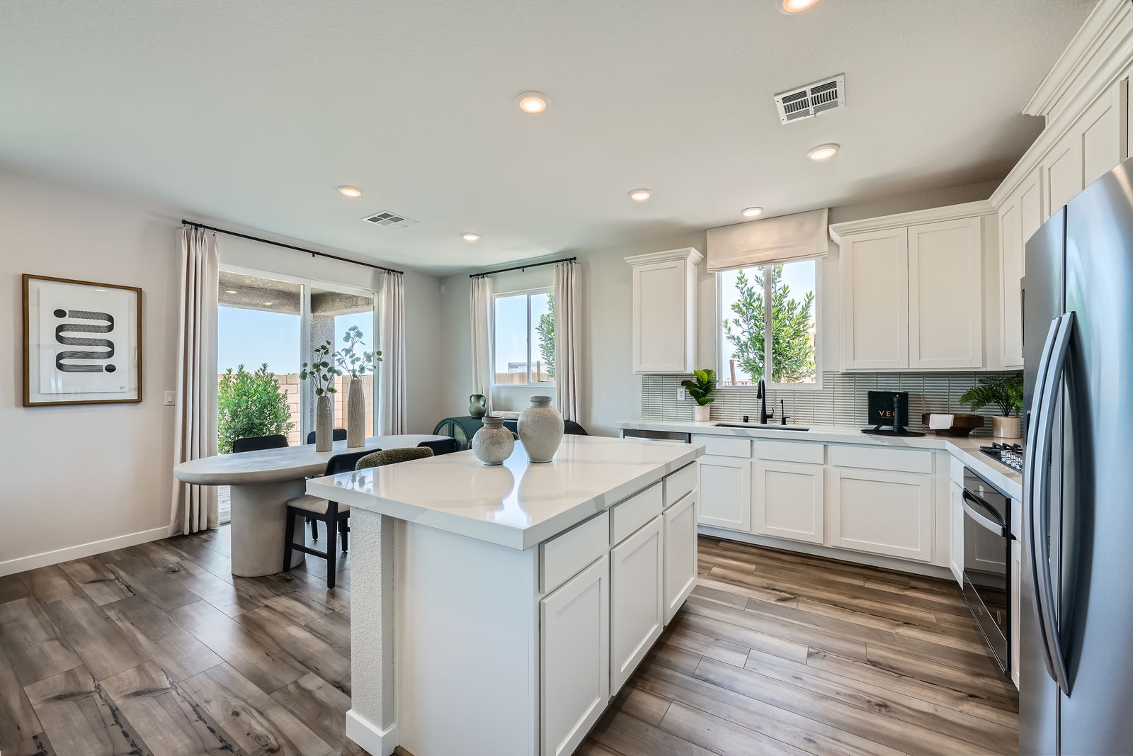 A kitchen with white cabinets.