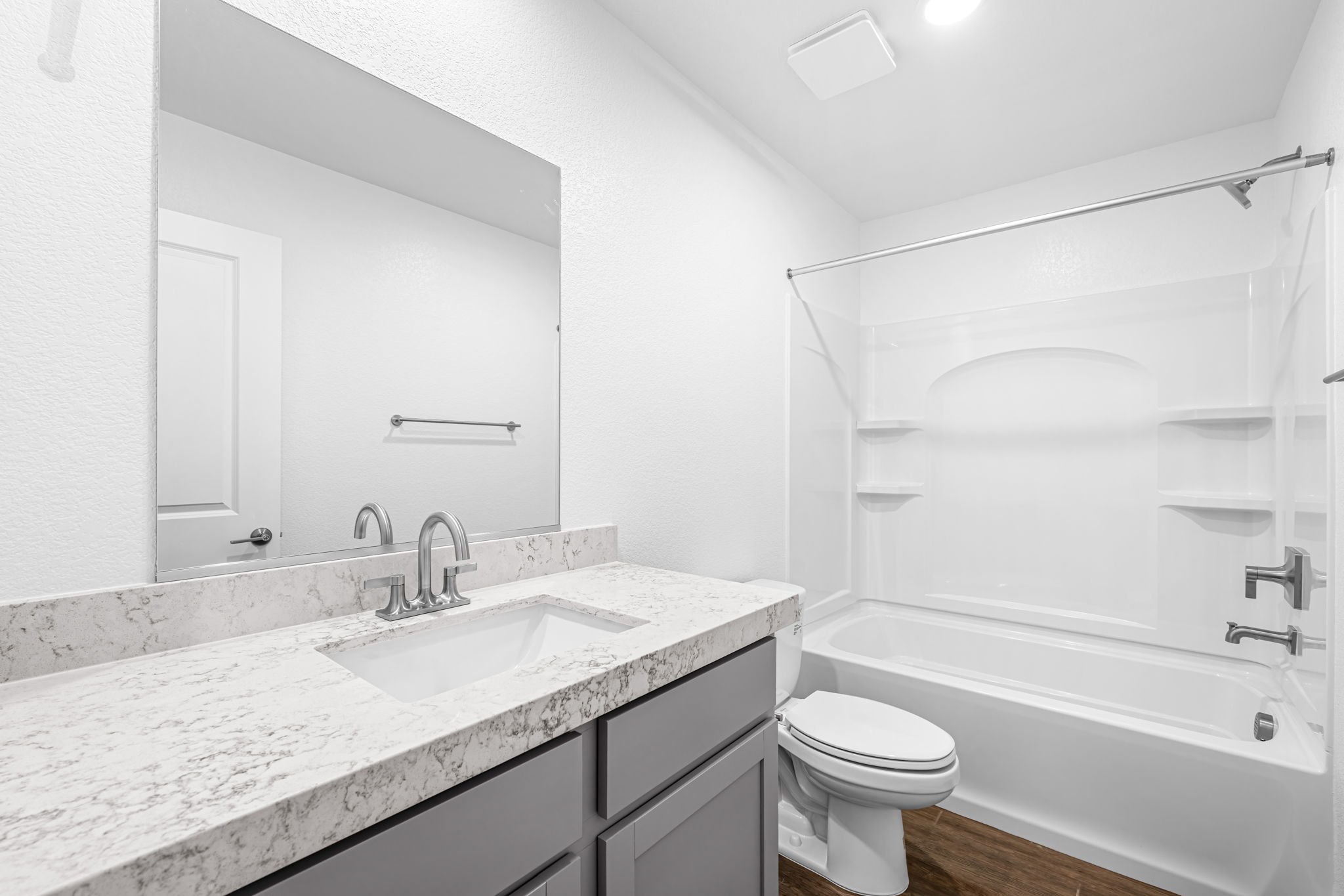 A bathroom with a tub sink and toilet.