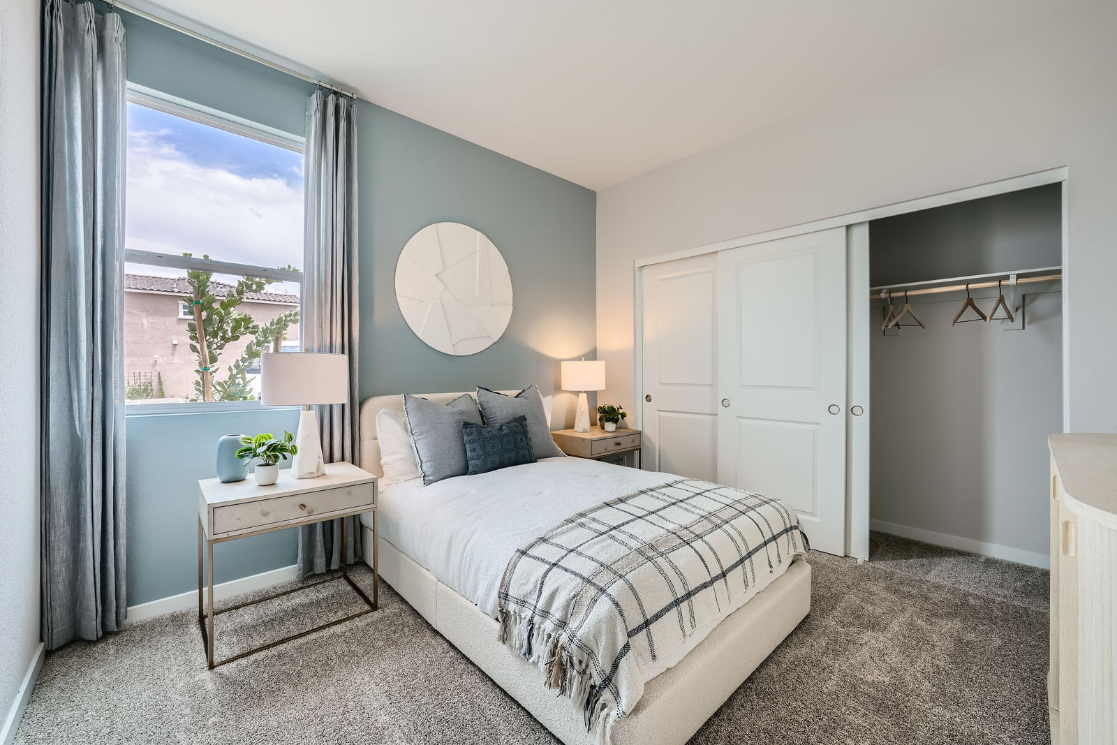 A bedroom with a bed and a table.