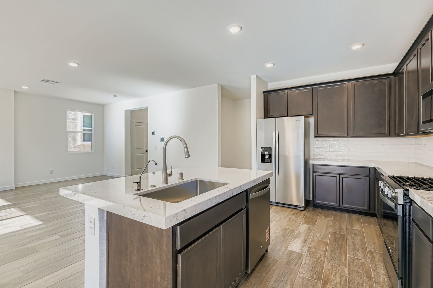 A kitchen with black cabinets.