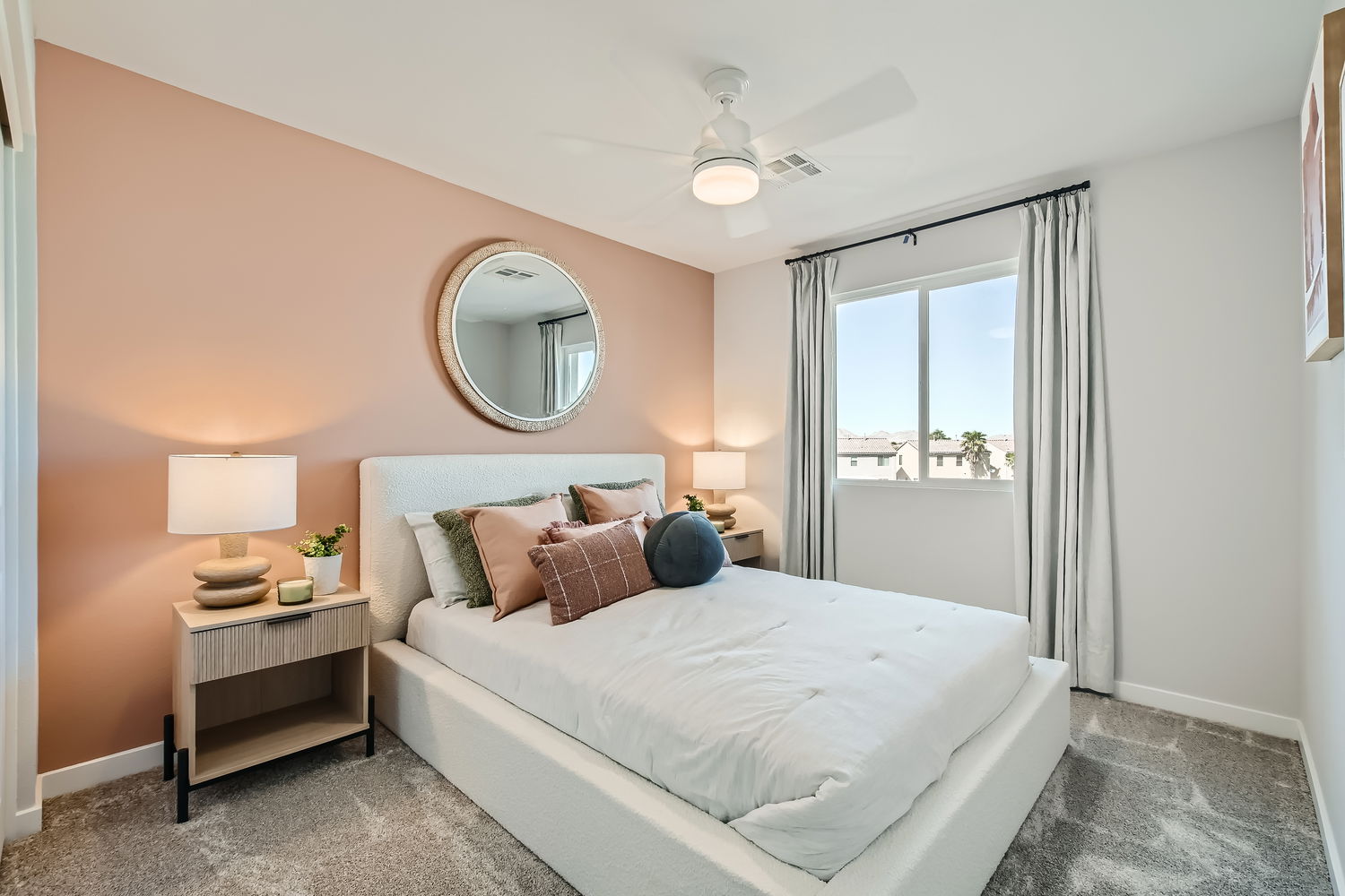 A bedroom with a large mirror.