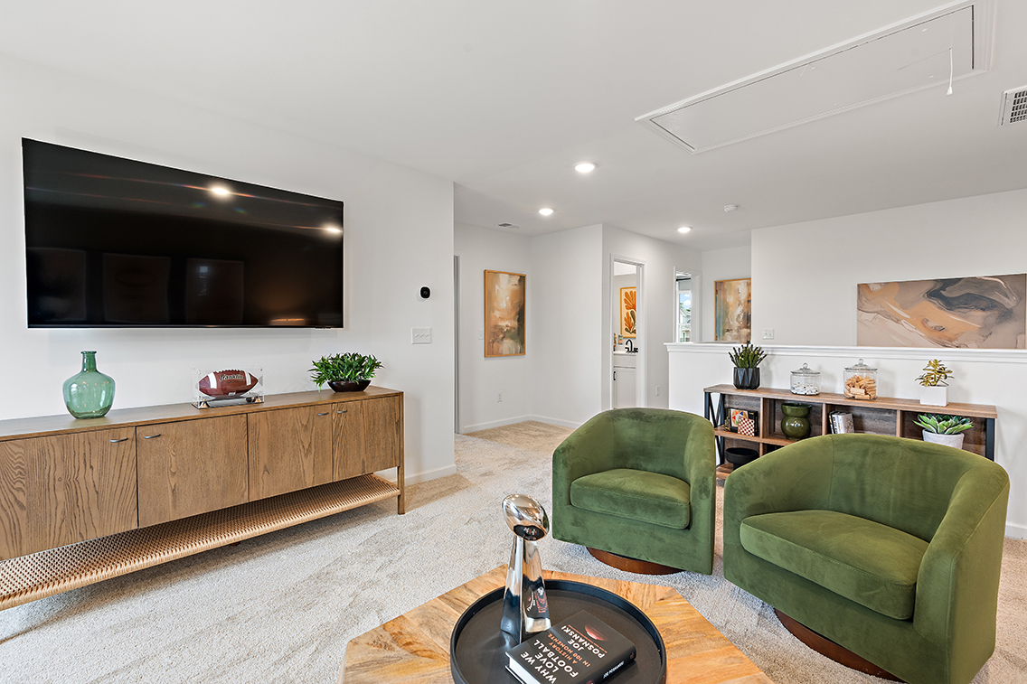 A living room with green chairs.