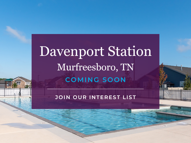 A large purple building with a pool in front of it.