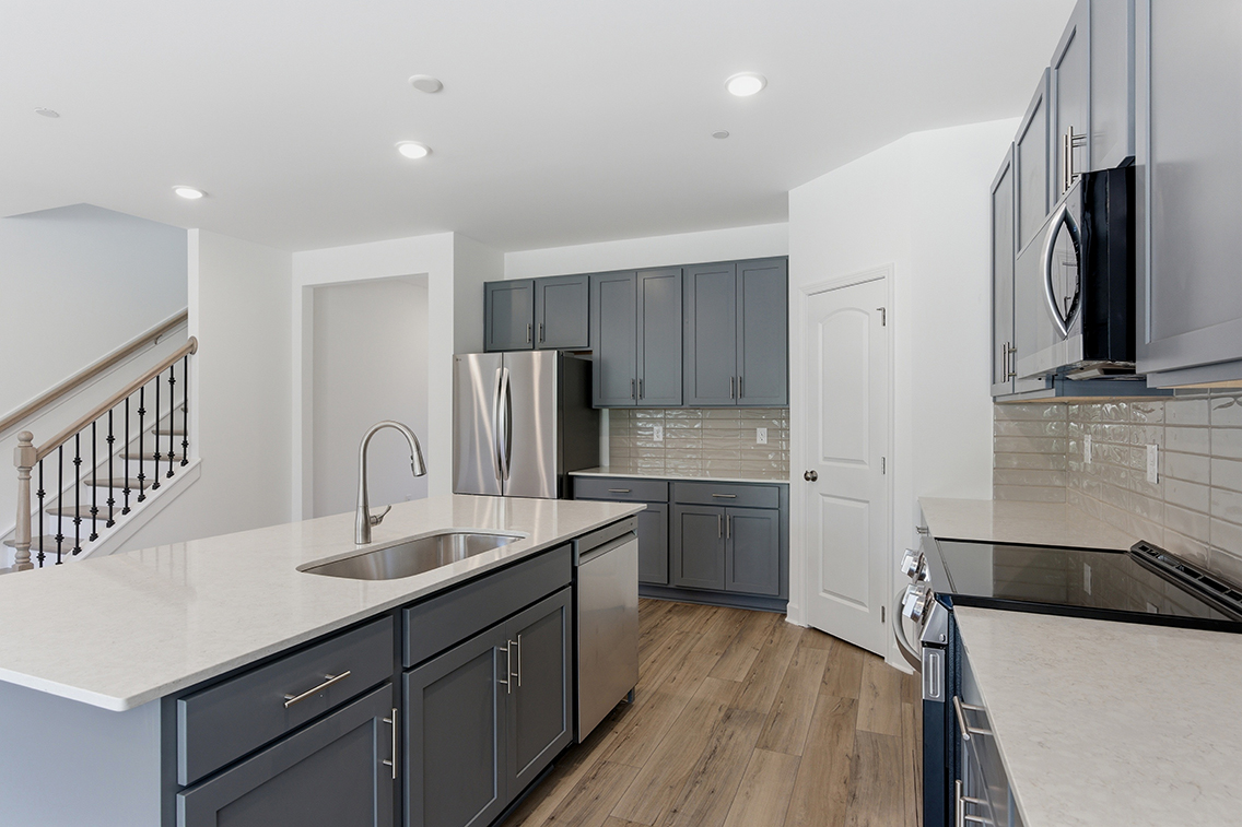 A kitchen with black cabinets.