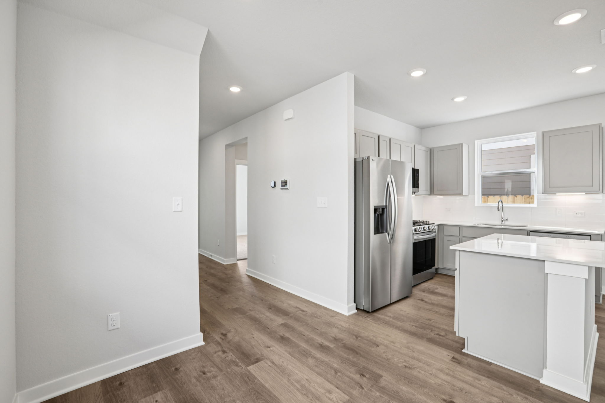 A kitchen with white cabinets.