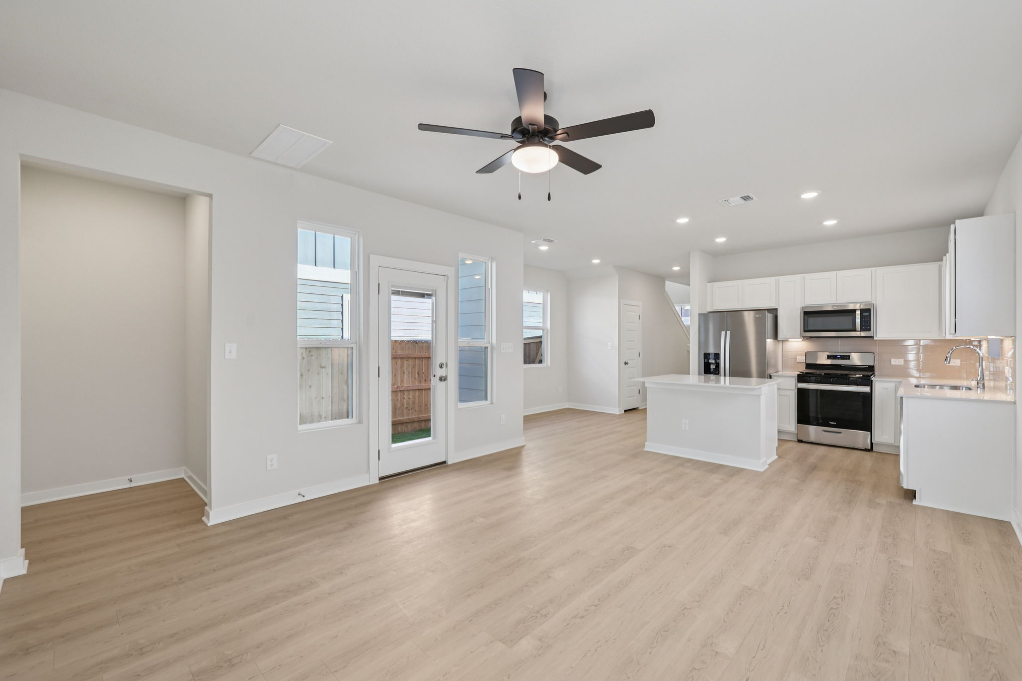 A large kitchen with white cabinets.