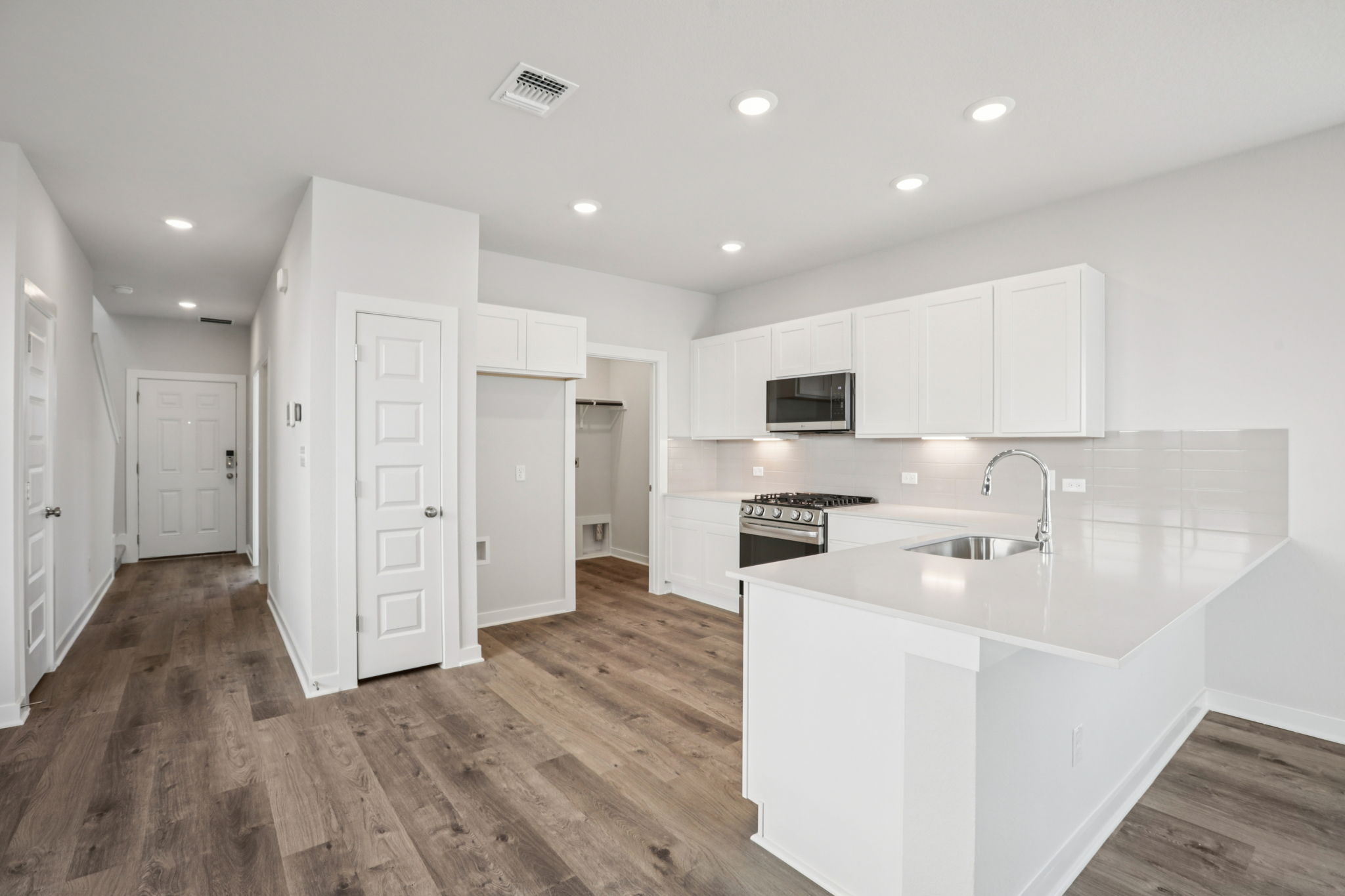 A kitchen with white cabinets.