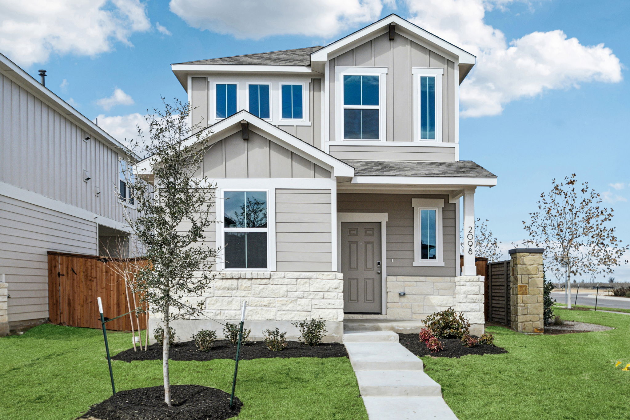 A white house with a driveway with Hitsville U.S.A. in the background.