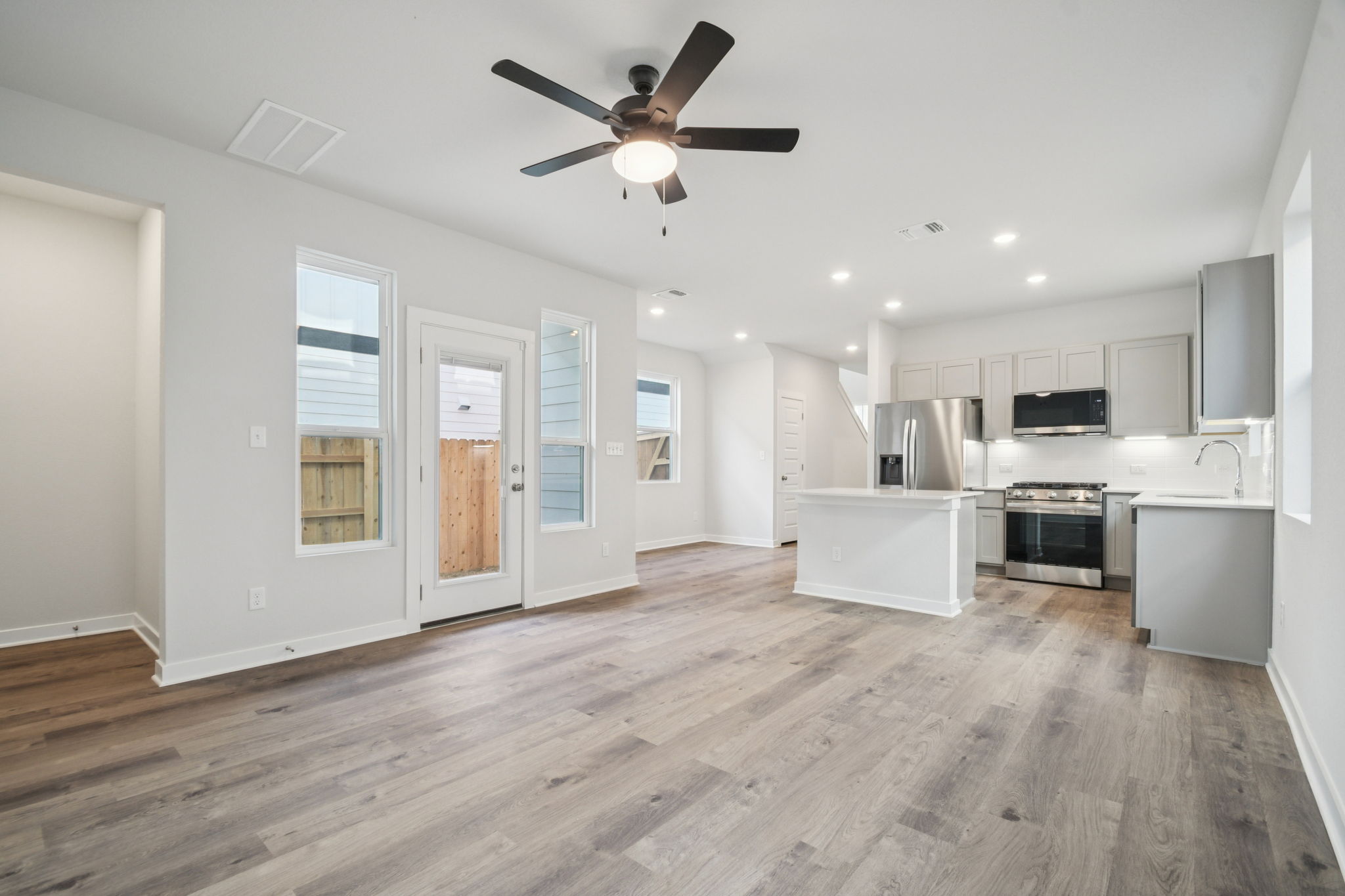 A kitchen with white cabinets.