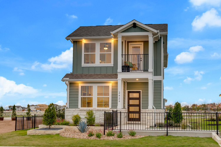 A house with a fence around it with Apsley House in the background.
