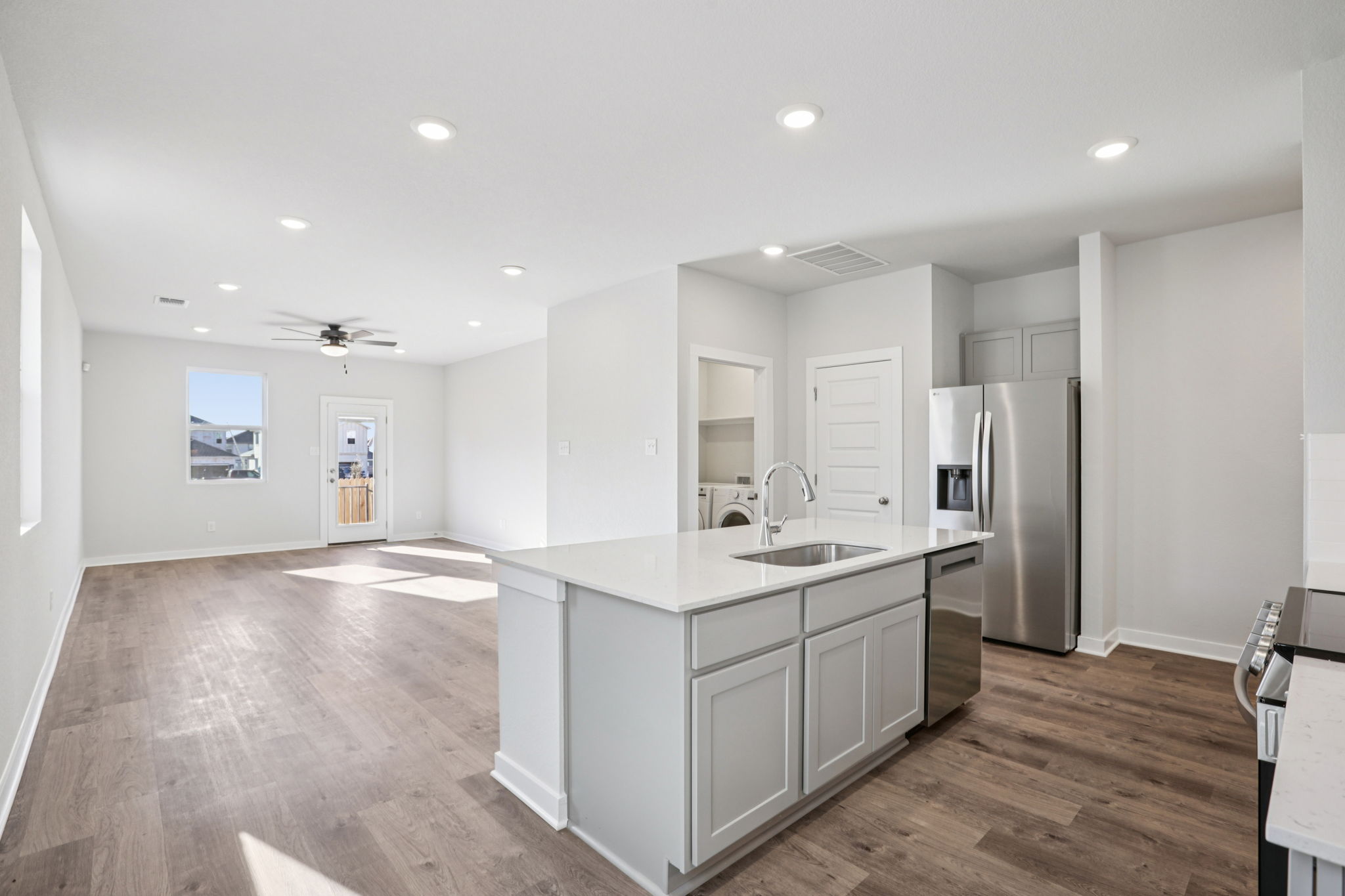 A kitchen with white cabinets.