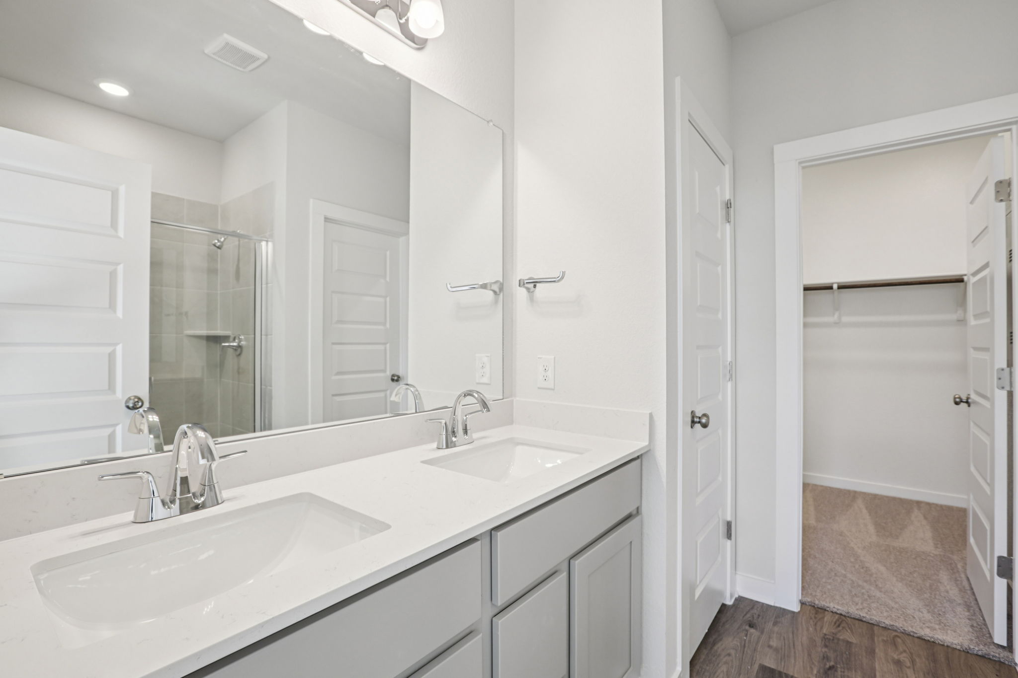 A bathroom with a large mirror.