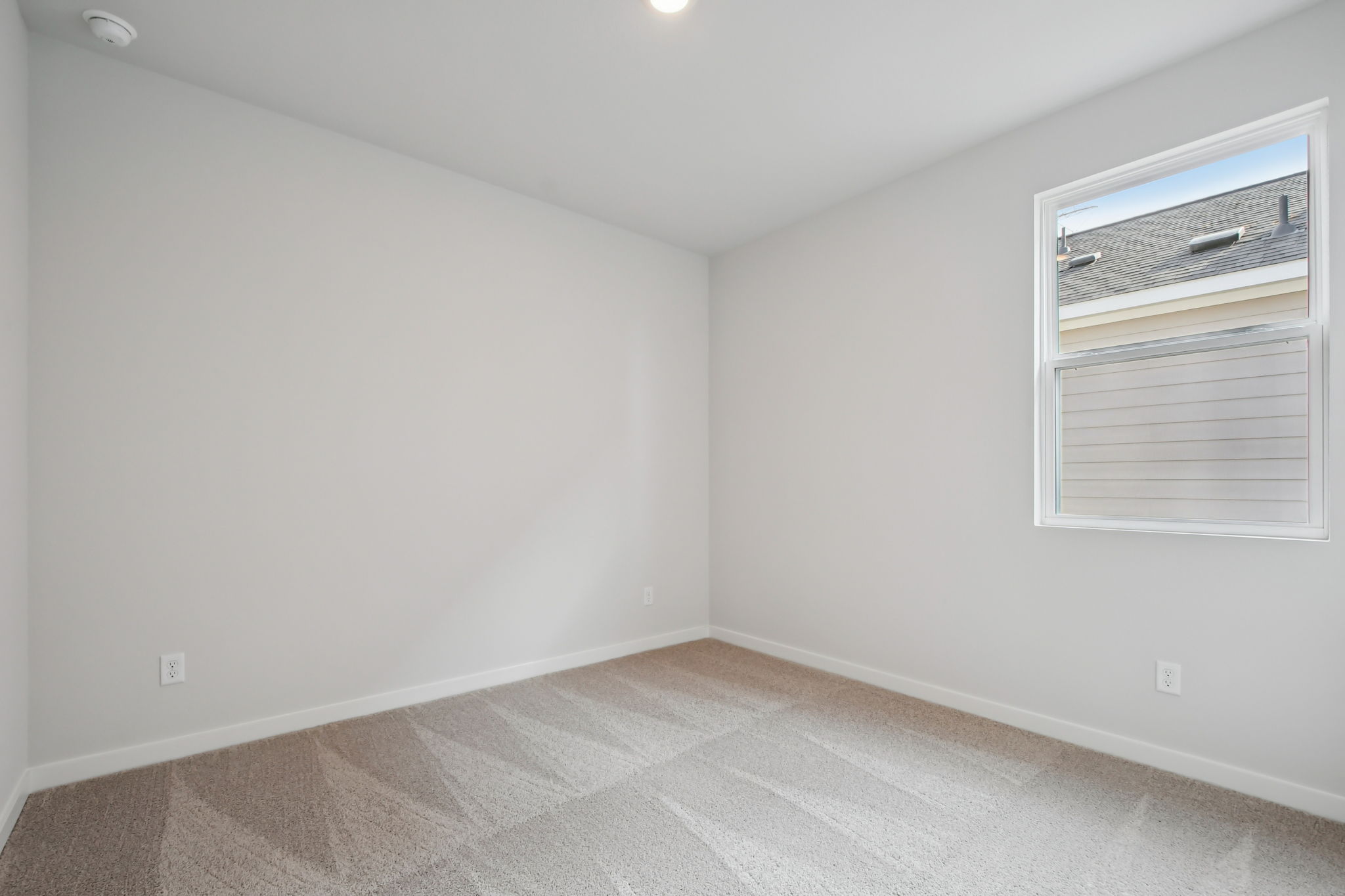 A room with a window and a vent.