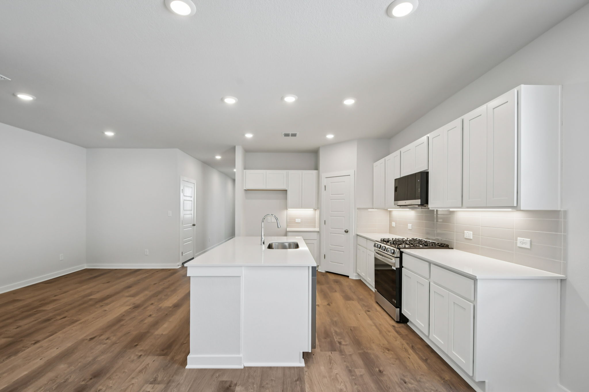 A kitchen with white cabinets.