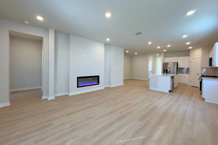 A large kitchen with a wood floor.