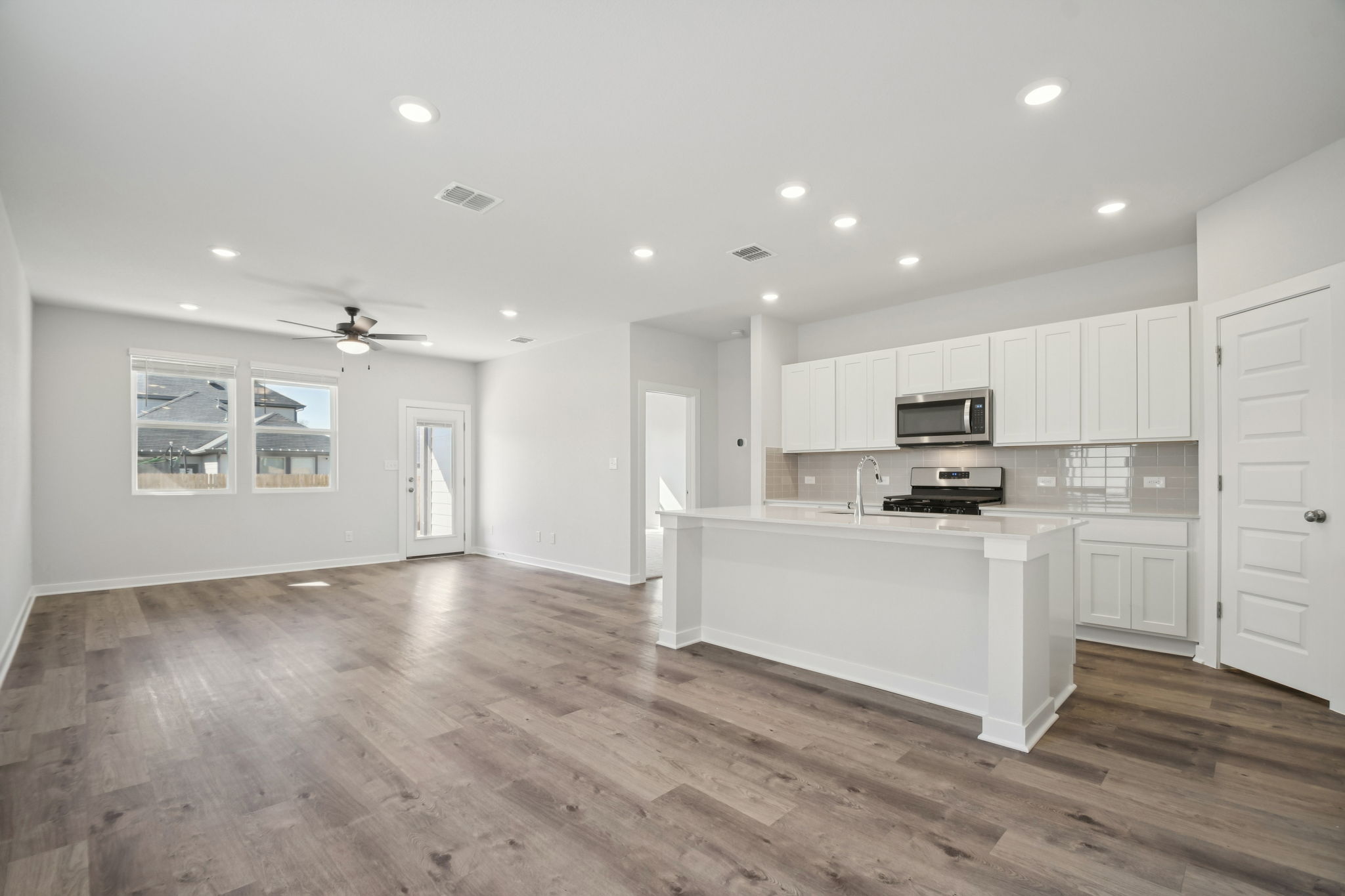 A kitchen with white cabinets.