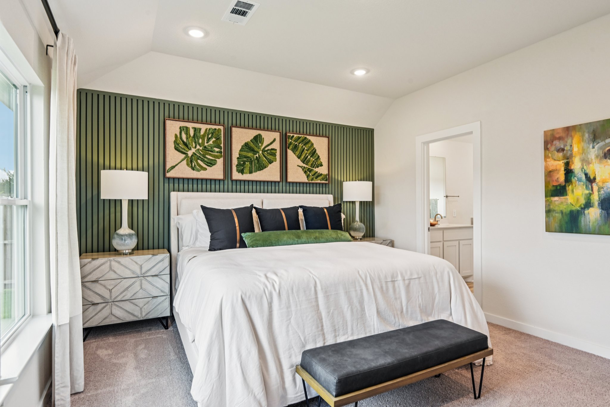 A bedroom with a bed and lamps.